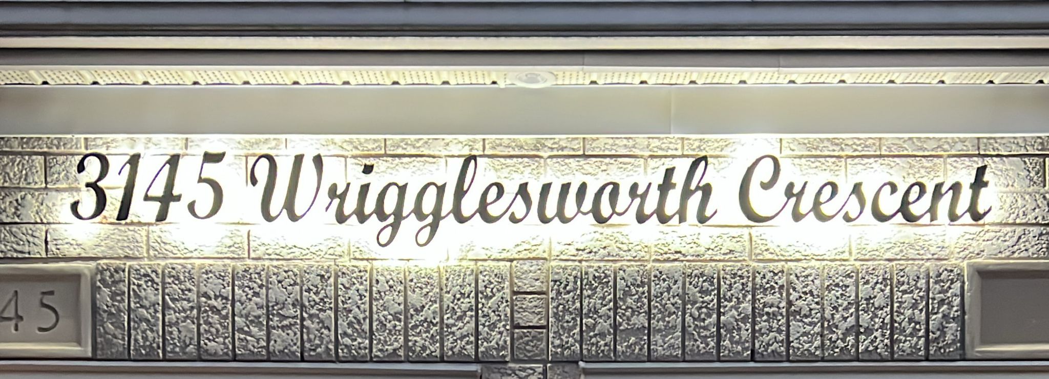 Modern home with warm LED address sign