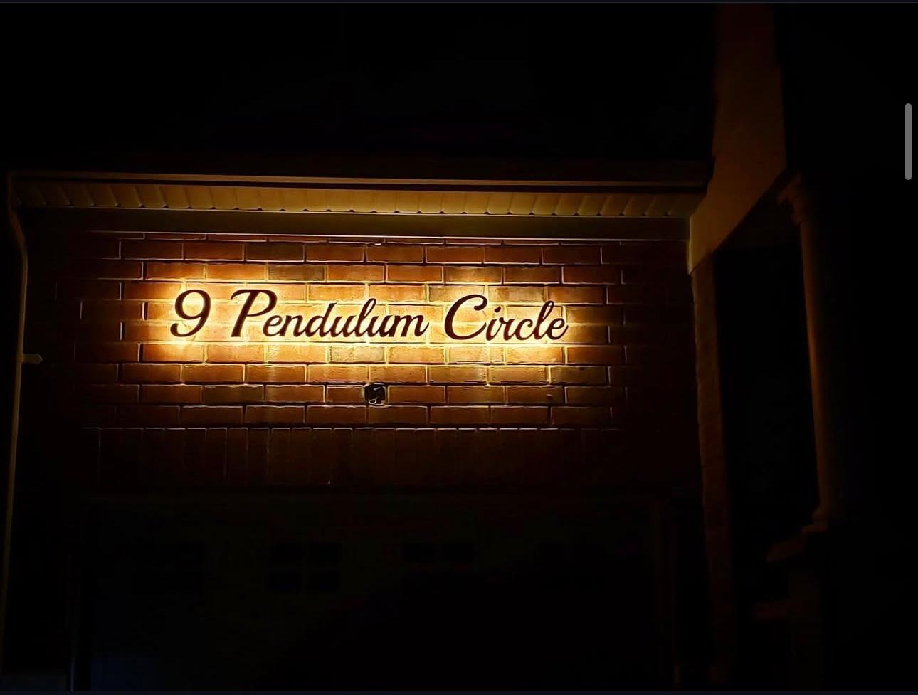Colonial home with bright address sign