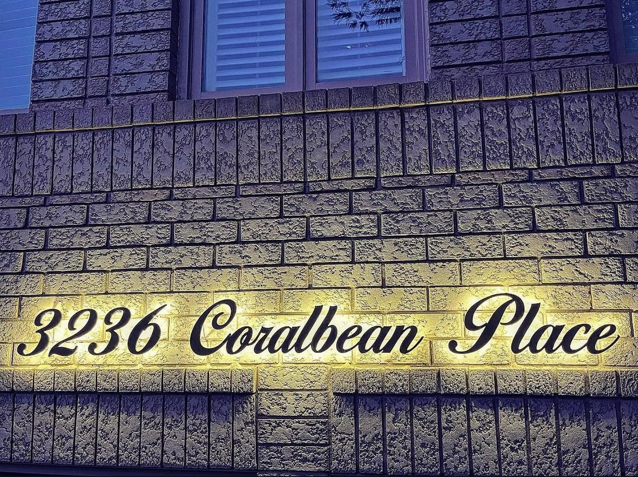 Modern home with illuminated address sign at night